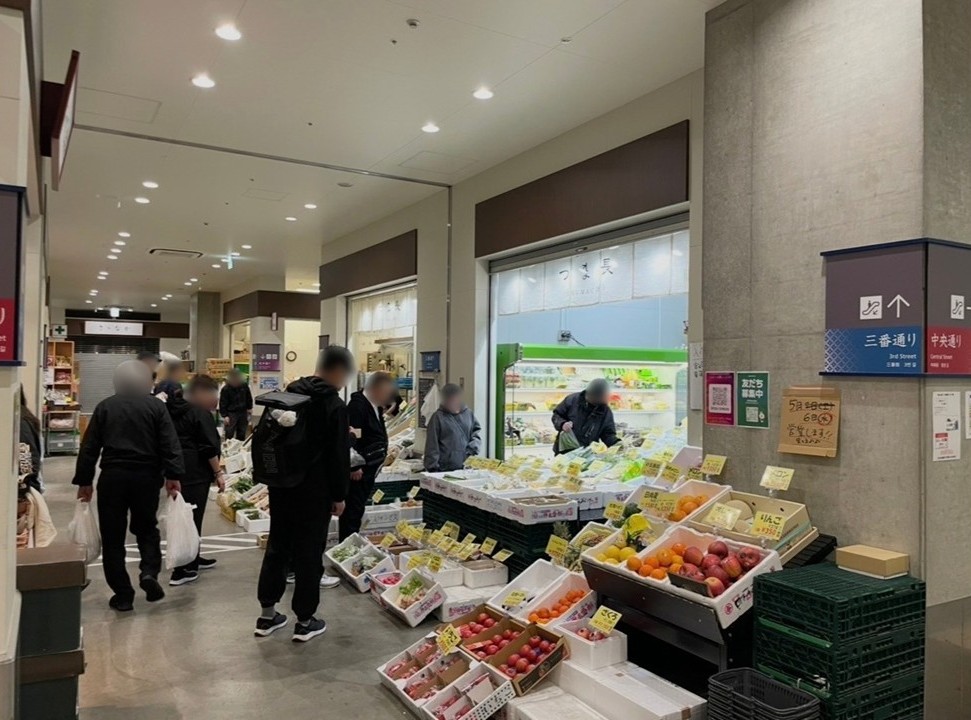 豐洲市場魚河岸橫丁的第二張場景，蔬果店林立、購物人潮熱鬧的街區。