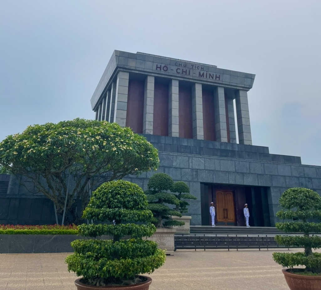 Solemn stone architecture and guards standing in the plaza at Hanoi’s Ho Chi Minh Mausoleum