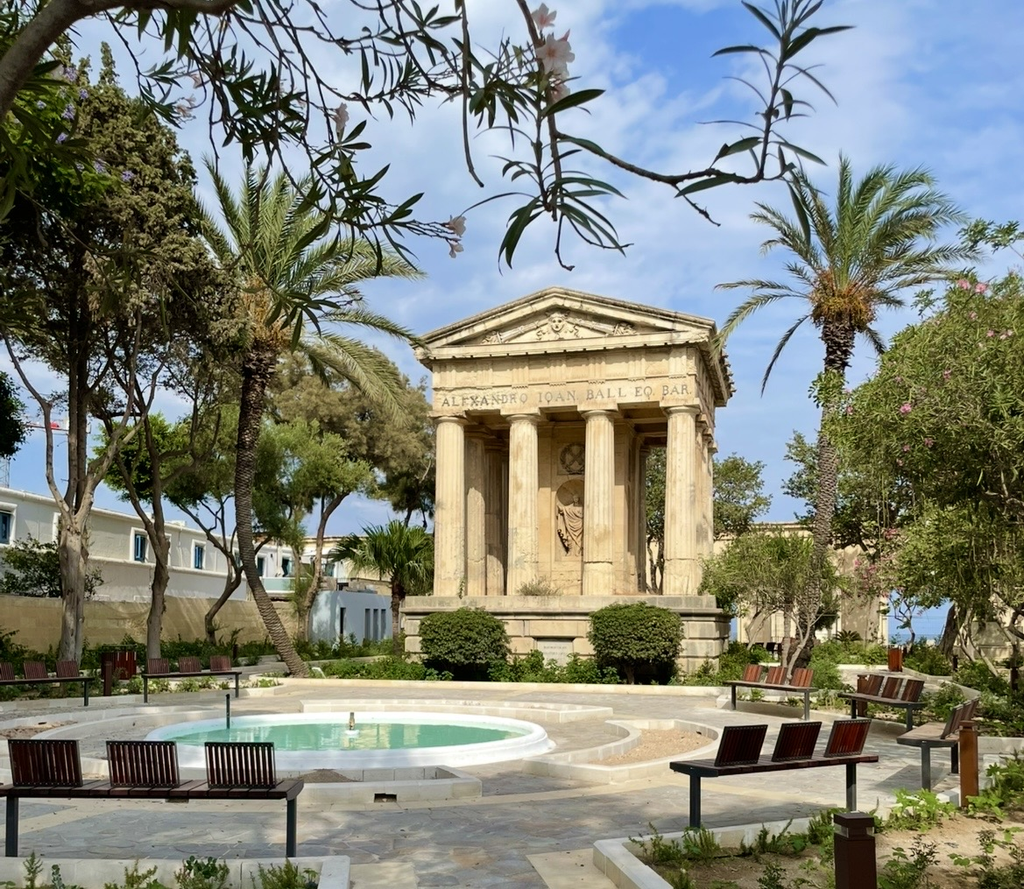The Alexander Ball Monument in the Lower Barrakka Gardens, a classical structure with rows of columns surrounded by greenery. A tranquil corner of the garden that reflects both history and elegance.
